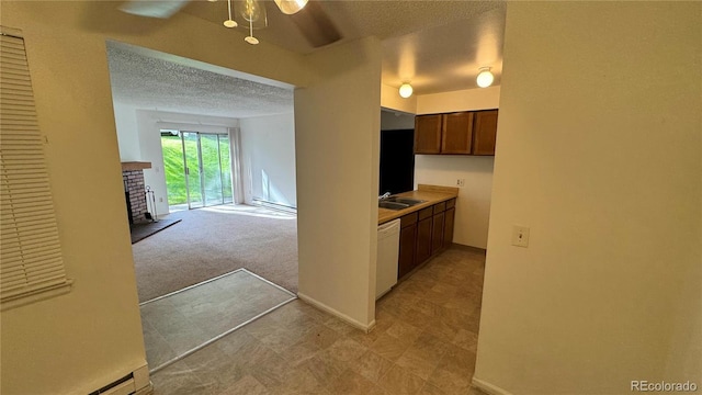 hallway featuring light carpet, a textured ceiling, and sink