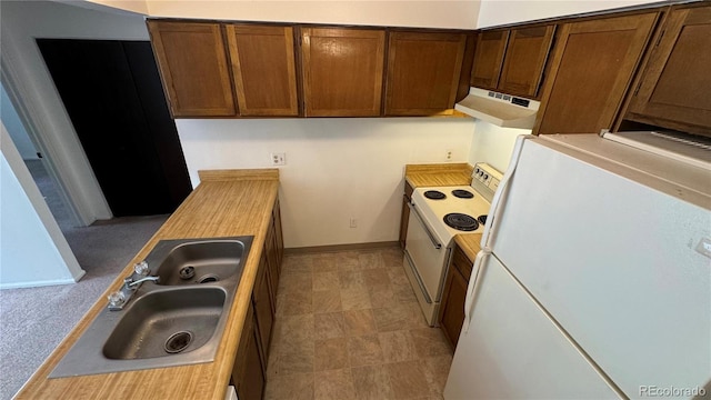 kitchen with sink, exhaust hood, and white appliances