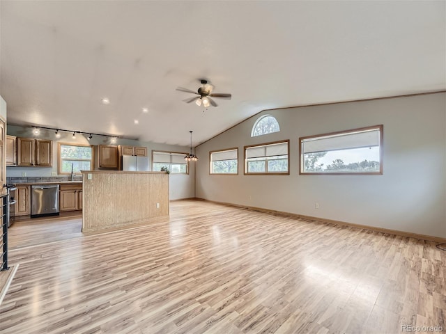 kitchen with stainless steel dishwasher, white fridge, light hardwood / wood-style flooring, and track lighting