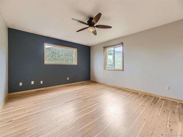 empty room with light wood-type flooring and ceiling fan