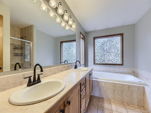 bathroom featuring plenty of natural light, separate shower and tub, vanity, and tile patterned floors