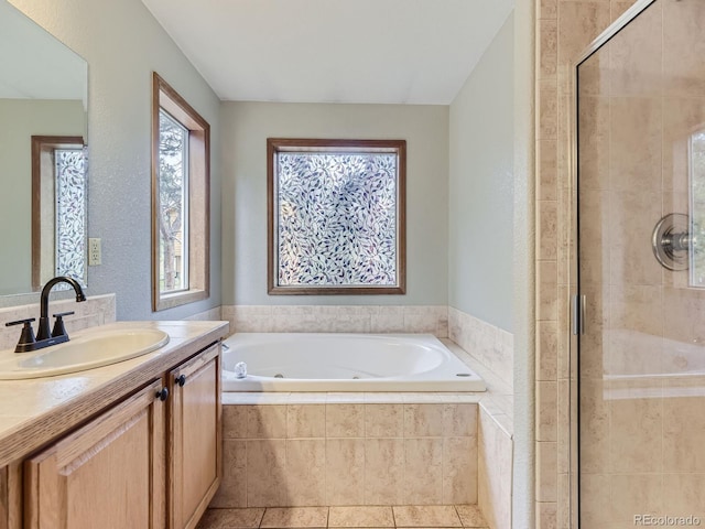 bathroom featuring a healthy amount of sunlight, vanity, separate shower and tub, and tile patterned floors