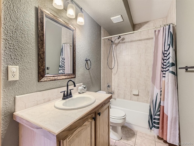 full bathroom with a textured ceiling, tile patterned flooring, vanity, shower / bath combo, and toilet