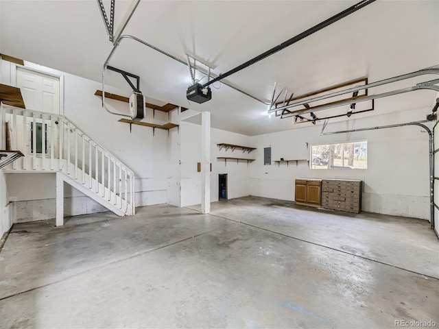 garage featuring a garage door opener and electric panel