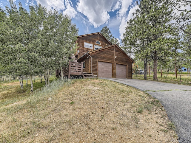 log cabin featuring a garage