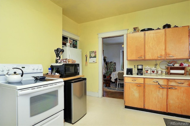 kitchen featuring refrigerator and white electric stove