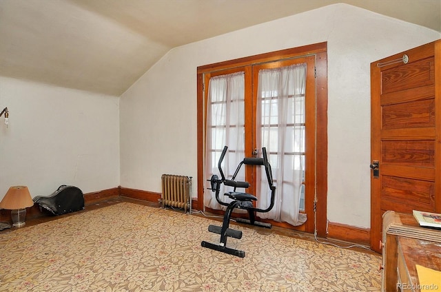 exercise room with radiator and lofted ceiling