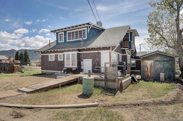 rear view of house featuring a shed