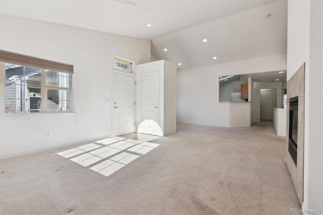 carpeted empty room featuring vaulted ceiling