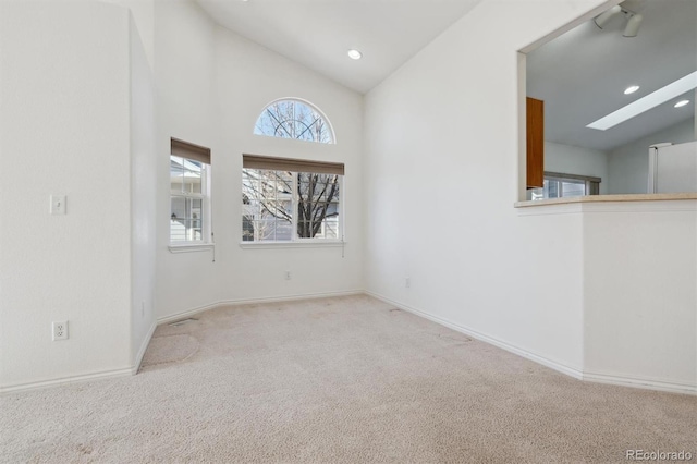 carpeted empty room featuring vaulted ceiling