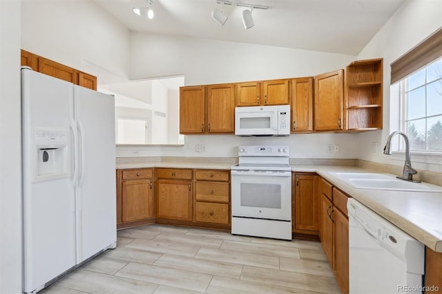 kitchen with white appliances, high vaulted ceiling, and sink