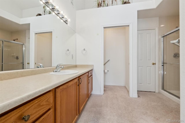 bathroom with a shower with door and vanity