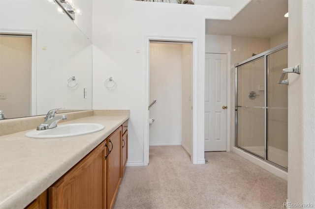 bathroom featuring vanity and an enclosed shower