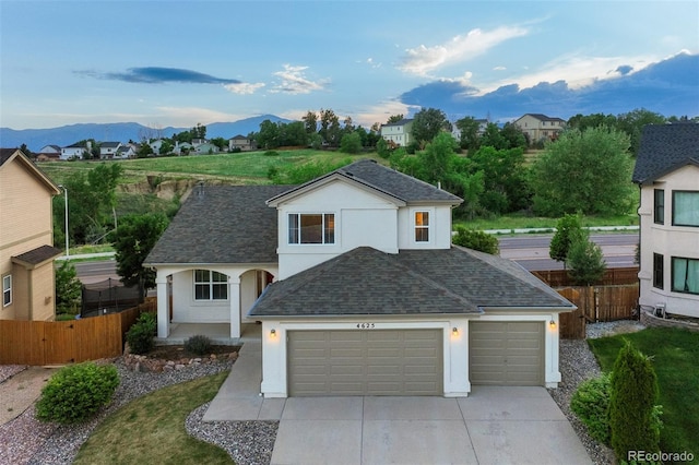 view of front facade featuring a garage and a mountain view