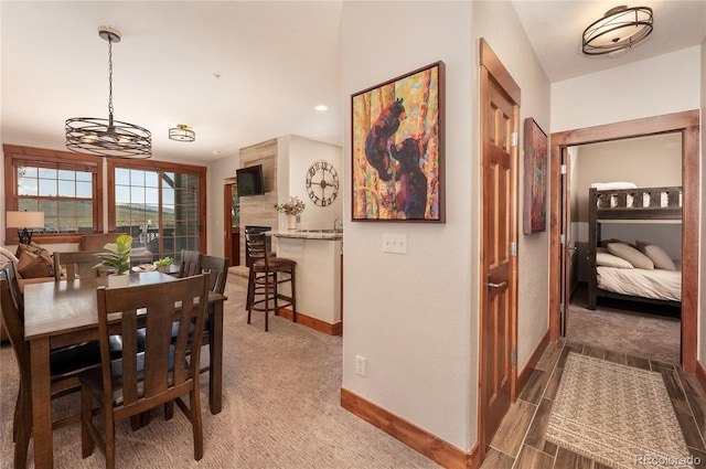 dining room with dark wood-type flooring and a notable chandelier