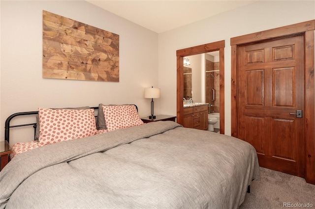 carpeted bedroom featuring connected bathroom