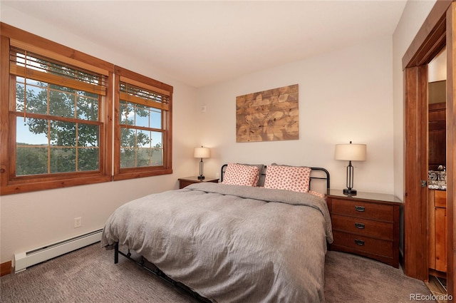 bedroom with a baseboard heating unit and carpet