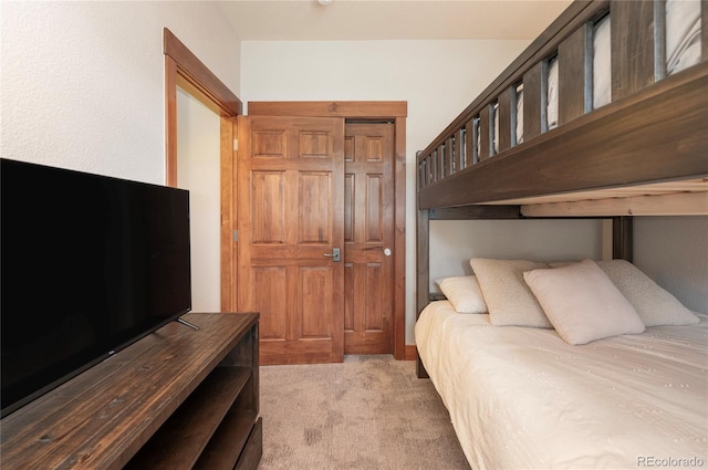 bedroom with a closet and light colored carpet