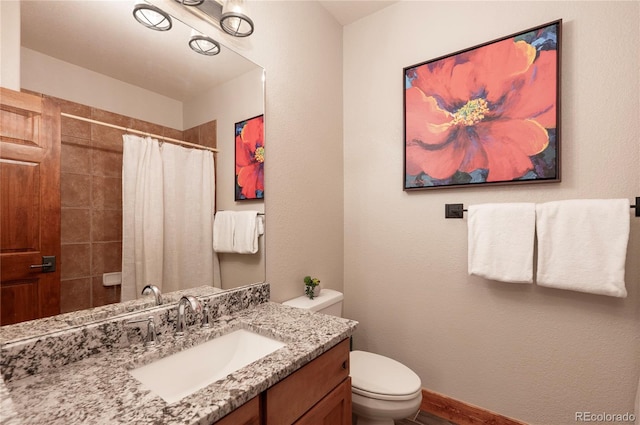 bathroom with toilet, curtained shower, and vanity