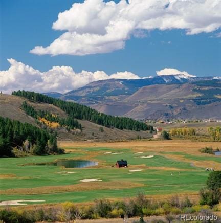 surrounding community with a water and mountain view