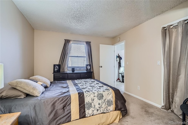 carpeted bedroom featuring a textured ceiling