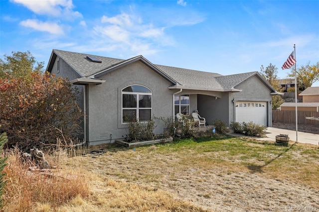 ranch-style house featuring a garage and a front yard