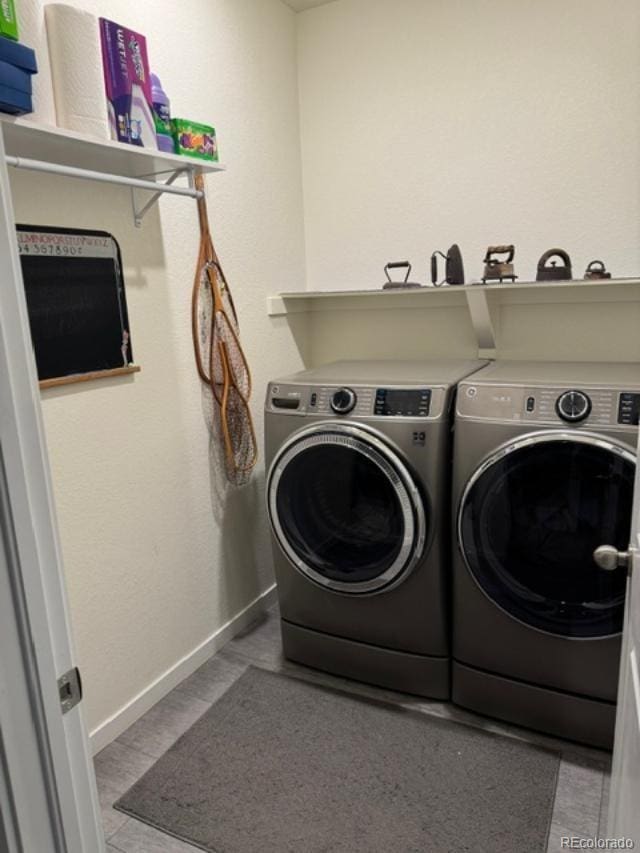 laundry room featuring washer and dryer, laundry area, and baseboards