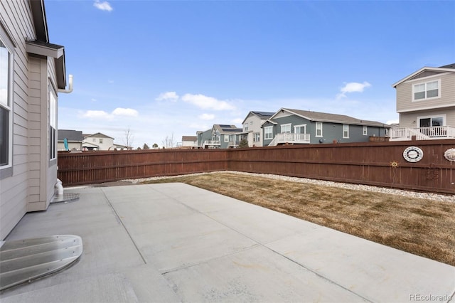 view of patio with a fenced backyard and a residential view