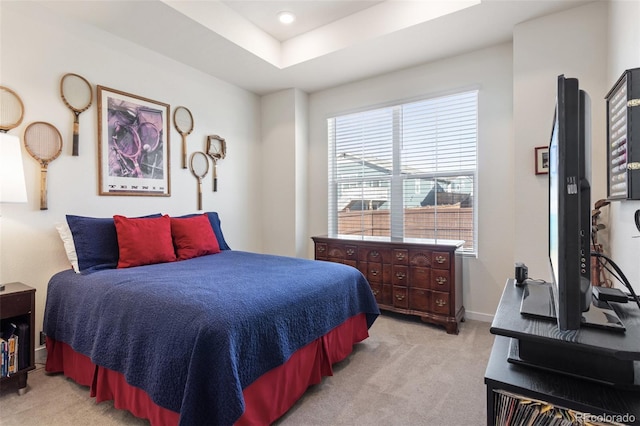 bedroom with recessed lighting, baseboards, a raised ceiling, and light colored carpet