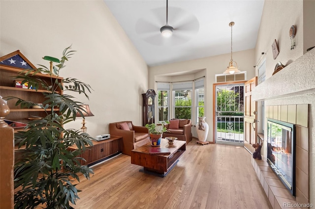 9869 Julian Way # B, Westminster, CO 80031 - living room featuring high vaulted ceiling, a ceiling fan, light wood finished floors, and a tile fireplace