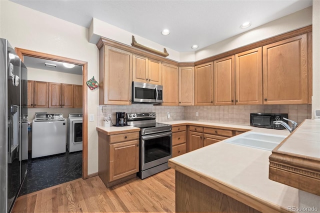 9869 Julian Way # B, Westminster, CO 80031 - kitchen featuring stainless steel appliances, independent washer and dryer, light countertops, tasteful backsplash, and recessed lighting
