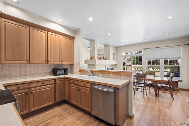 9869 Julian Way # B, Westminster, CO 80031 - kitchen with stainless steel dishwasher, black microwave, a peninsula, decorative backsplash, and light wood-type flooring