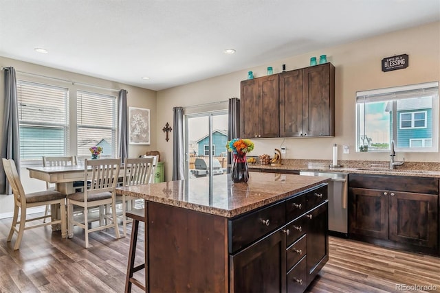 304 S 2nd Ave, Deer Trail, CO 80105 - kitchen featuring wood finished floors, a kitchen island, a sink, stone countertops, and dark brown cabinetry