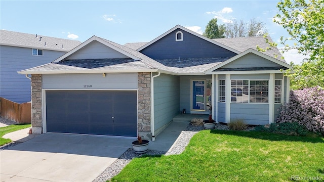 11560 River Run Cir, Commerce City, CO 80640 - ranch-style house featuring roof with shingles, an attached garage, a front yard, driveway, and stone siding