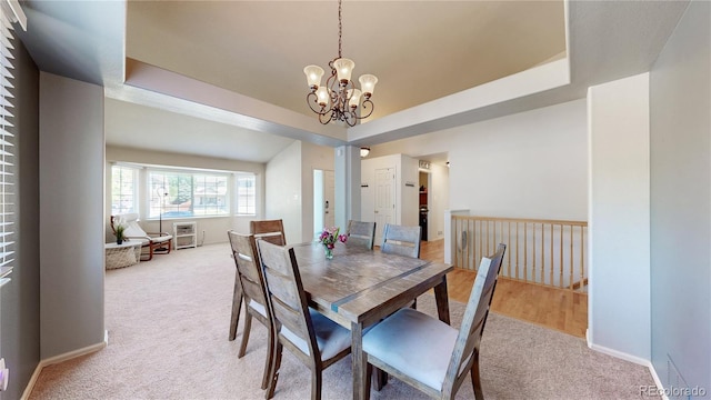 11560 River Run Cir, Commerce City, CO 80640 - dining room with light colored carpet, a chandelier, baseboards, and a raised ceiling