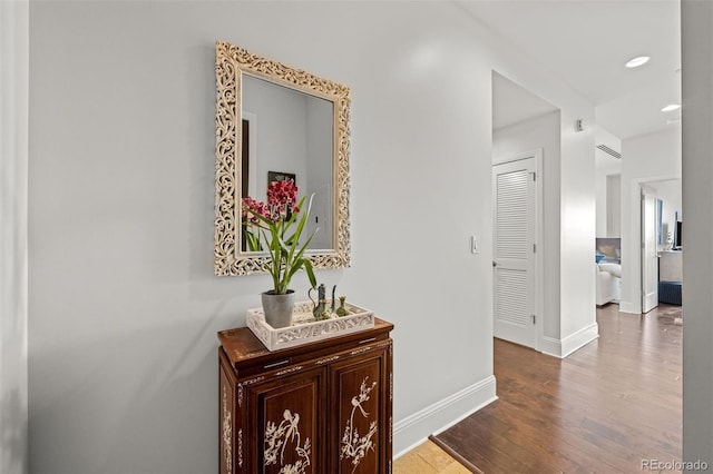 corridor with hardwood / wood-style floors