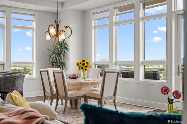 dining area with wood-type flooring and a chandelier