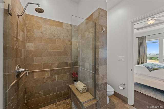 bathroom featuring toilet and tiled shower