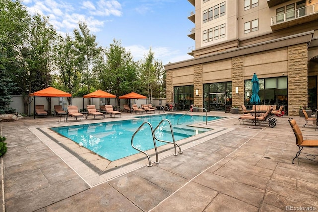 view of pool featuring a gazebo, an outdoor living space, and a patio area