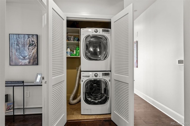 laundry room with dark hardwood / wood-style floors and stacked washer and clothes dryer