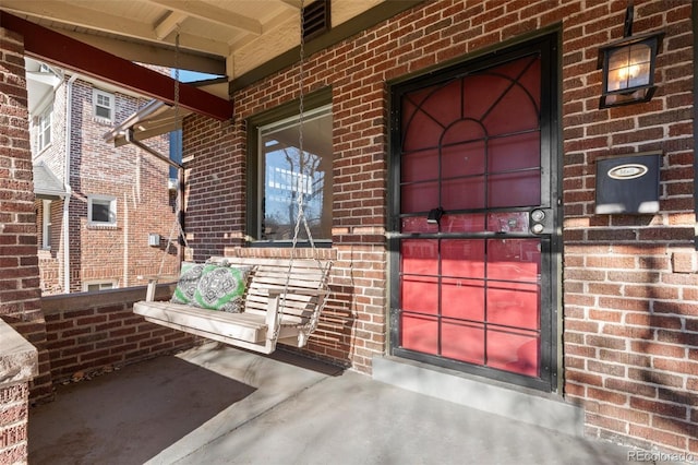 view of exterior entry featuring a porch