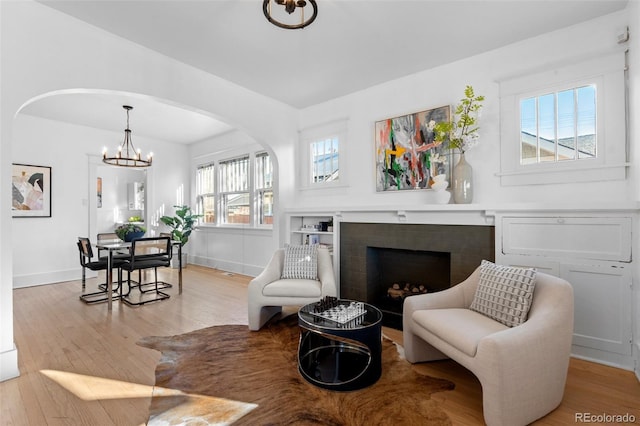 living room featuring light hardwood / wood-style floors and a notable chandelier