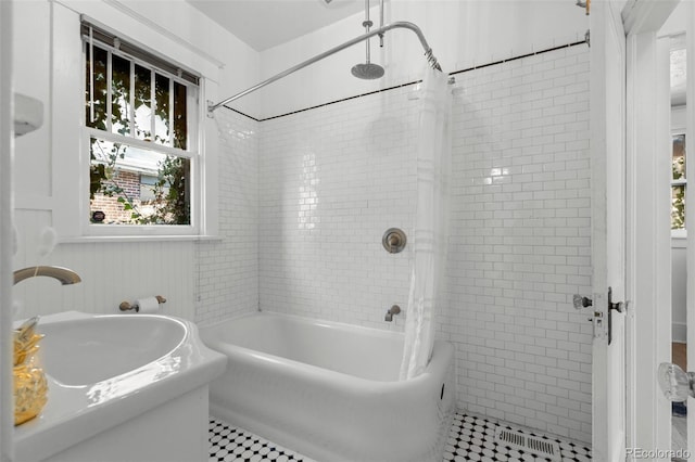 bathroom featuring shower / bathtub combination with curtain and tile patterned floors