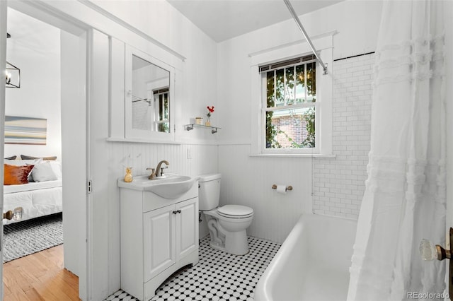 full bathroom featuring toilet, vanity, and shower / bath combo with shower curtain