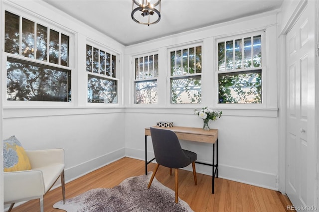 home office featuring an inviting chandelier and wood-type flooring