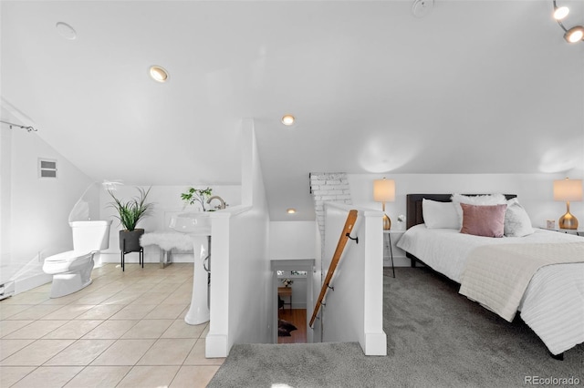 bedroom featuring light tile patterned floors and vaulted ceiling