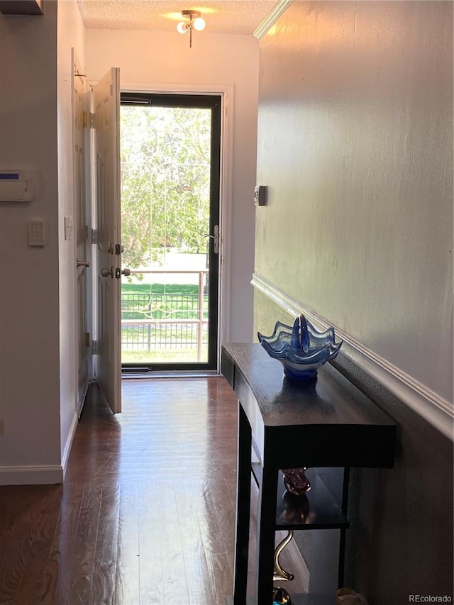 entryway featuring wood finished floors and baseboards