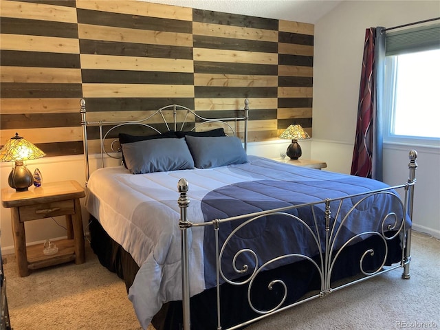 bedroom with carpet and wood walls