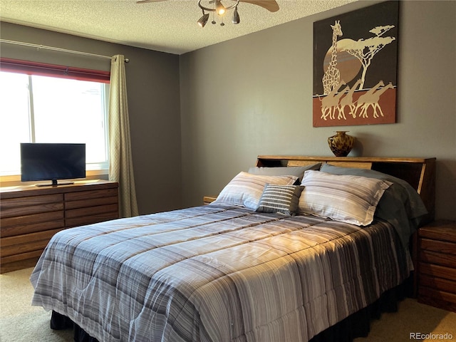bedroom featuring carpet and a textured ceiling