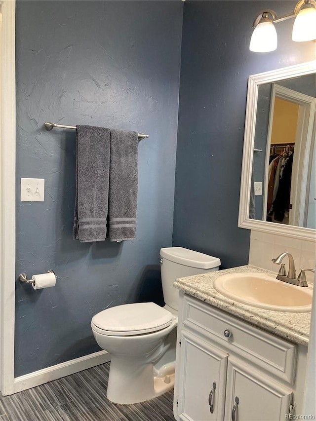 bathroom with toilet and vanity